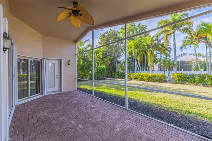 Unfurnished sunroom featuring a wealth of natural light and ceiling fan