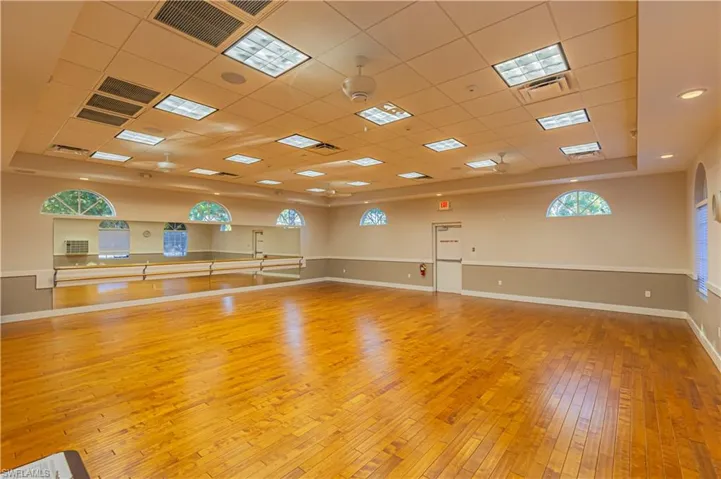 Spare room featuring baseboards, visible vents, and hardwood / wood-style floors