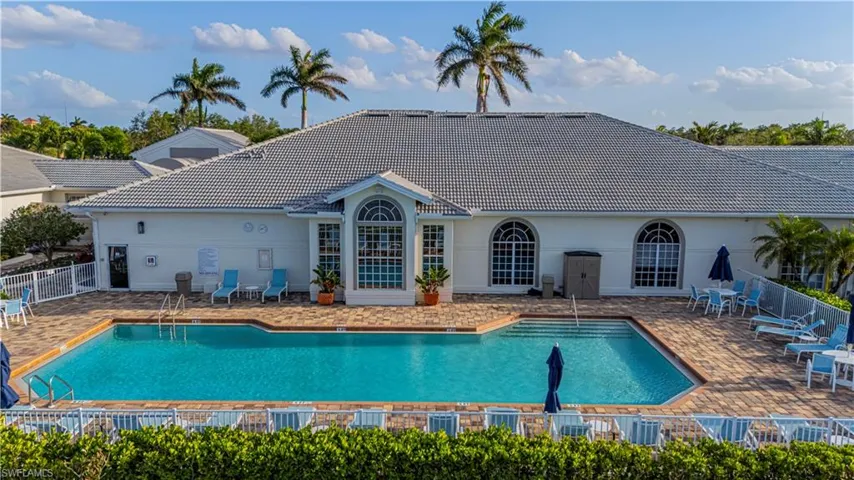 Community pool with fence and a patio area