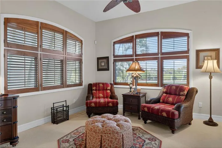 Sitting area with carpet floors and a ceiling fan