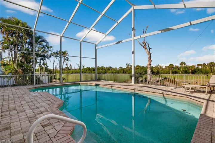 Outdoor pool featuring a patio and glass enclosure