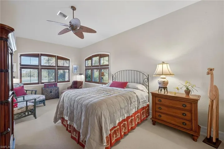 Bedroom featuring a ceiling fan and light colored carpet