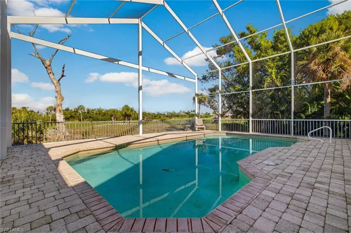 View of swimming pool featuring a patio, a lanai, and a sunroom