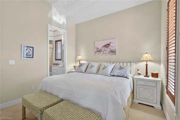 Bedroom featuring carpet floors and ensuite bath