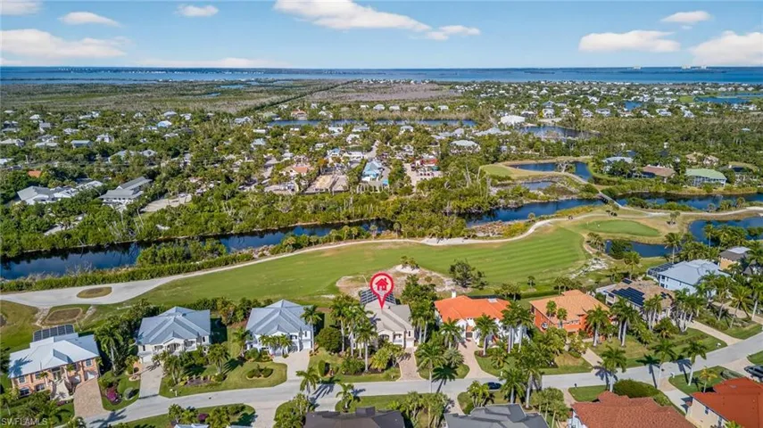 View of property location with nearby suburban area, a large body of water, and a local golf course