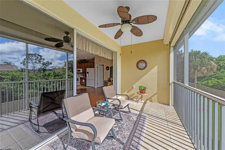 Sunroom / solarium featuring ceiling fan
