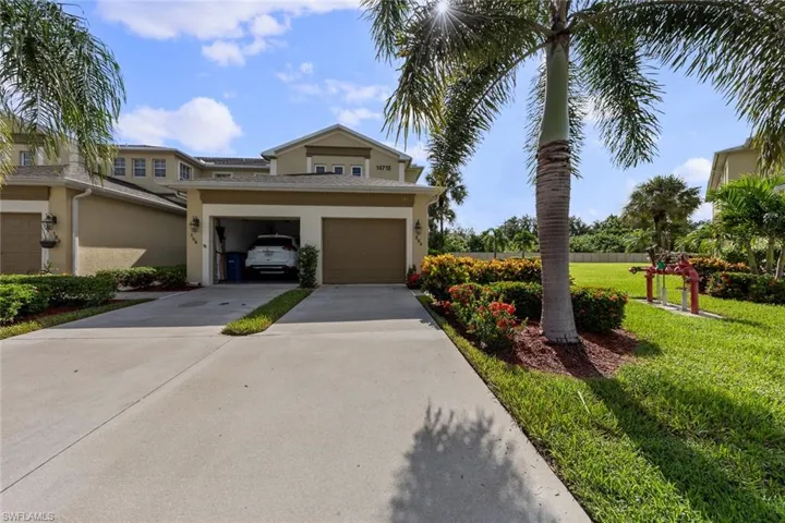 View of front of home with a garage and a front lawn