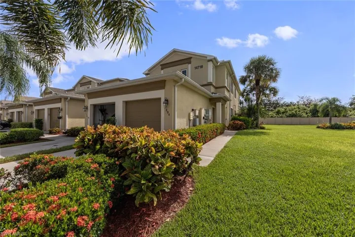 View of property exterior with a garage and a yard
