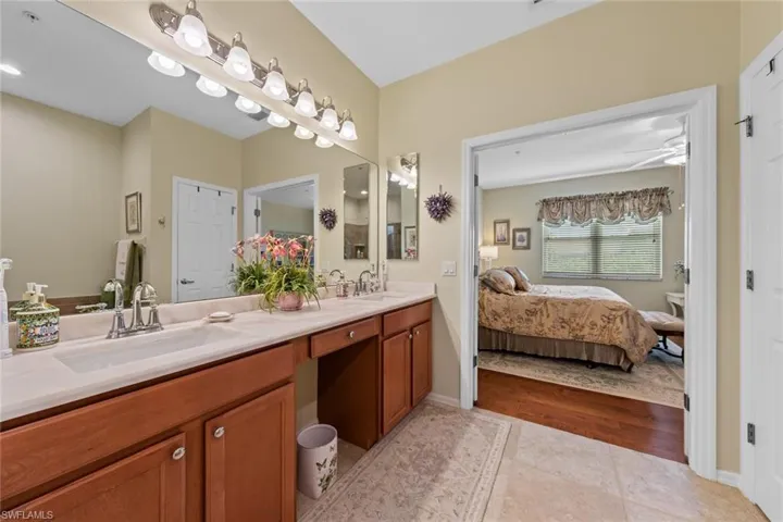 Bathroom featuring vanity, hardwood / wood-style flooring, and ceiling fan