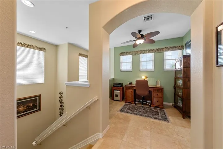 Office area with ceiling fan and light tile patterned floors
