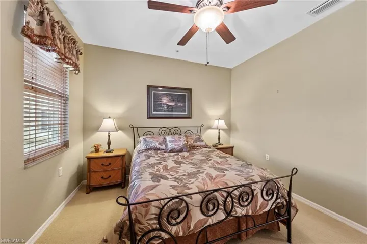 Bedroom featuring ceiling fan and light colored carpet