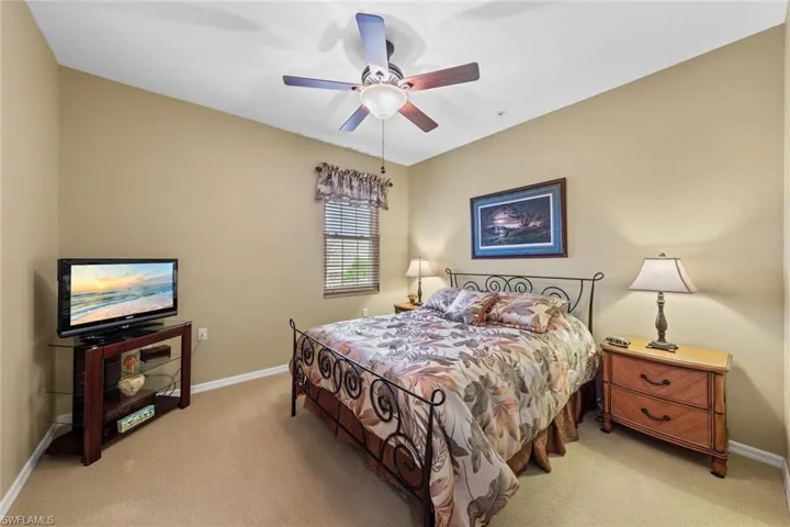 Bedroom featuring ceiling fan and light colored carpet