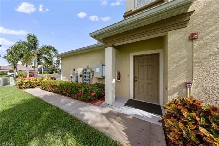 View of exterior entry featuring a lawn