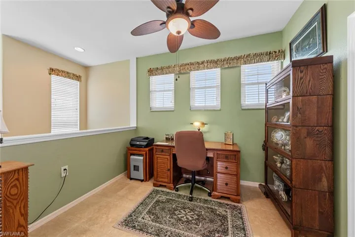 Home office featuring ceiling fan and light tile patterned floors