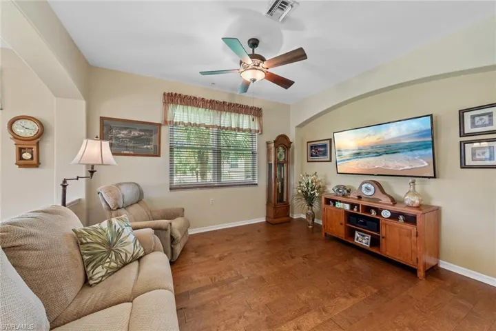 Living room featuring ceiling fan and dark hardwood / wood-style floors