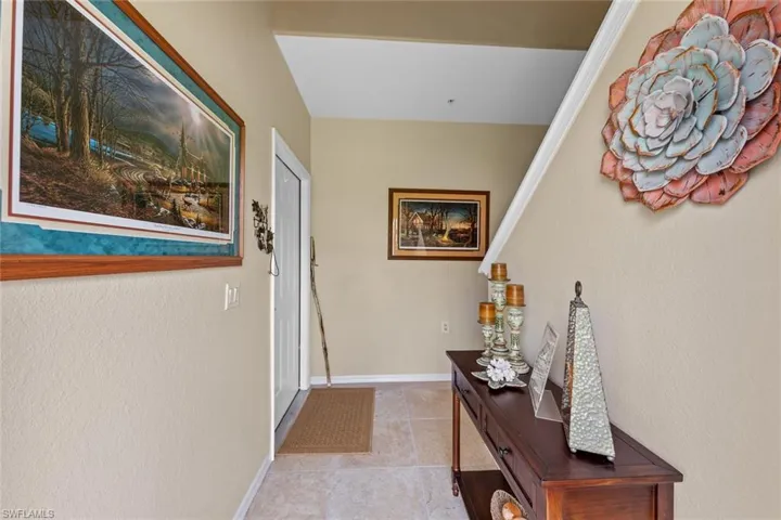 Hallway featuring light tile patterned flooring