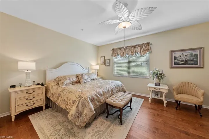 Bedroom with ceiling fan and dark hardwood / wood-style flooring