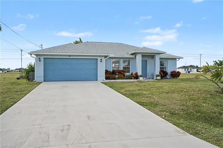 Single-story exterior featuring a hip roof, stucco facade, concrete driveway, two-car garage, and a covered entryway