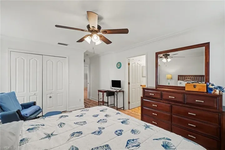 Interior space featuring crown molding, a central ceiling fan with integrated lighting, and multi-panel interior doors