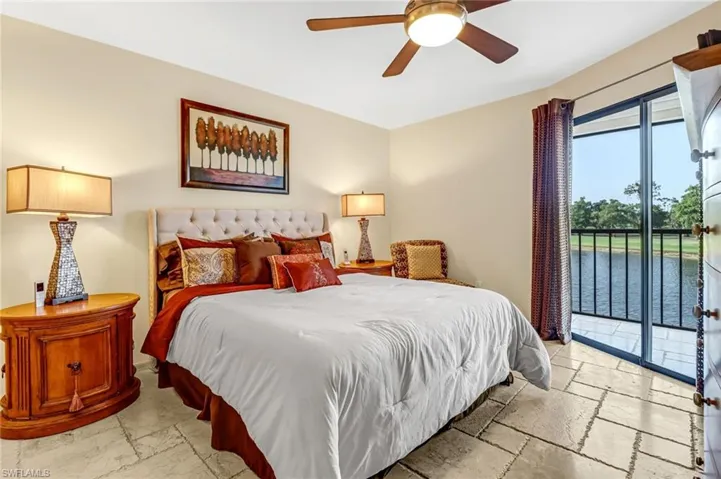 Bedroom featuring light tile floors, ceiling fan, and access to exterior