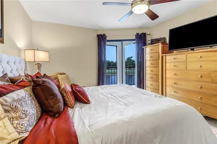 Bedroom with ceiling fan and access to outside