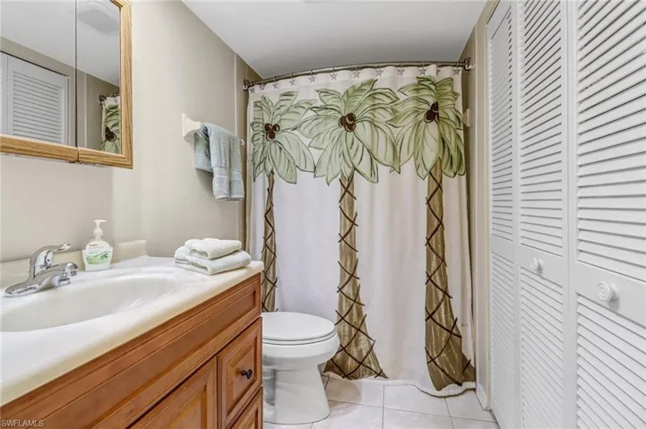 Bathroom with tile floors, vanity, and toilet