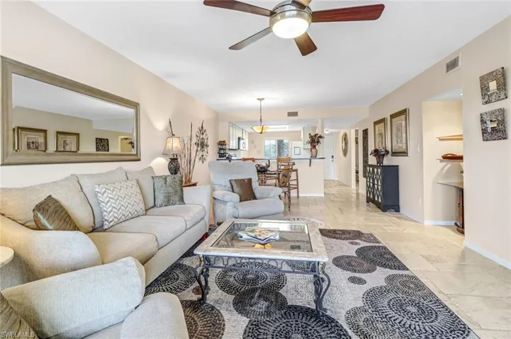 Living room with light tile flooring and ceiling fan
