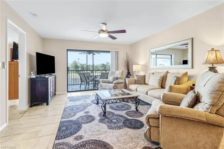 Tiled living room featuring ceiling fan