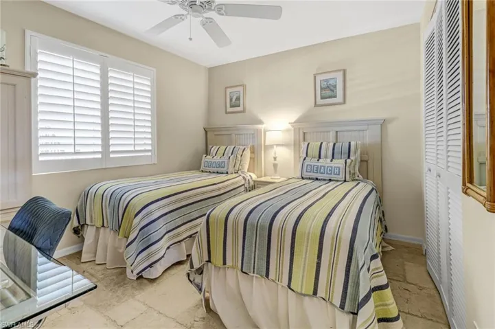 Tiled bedroom featuring a closet and ceiling fan