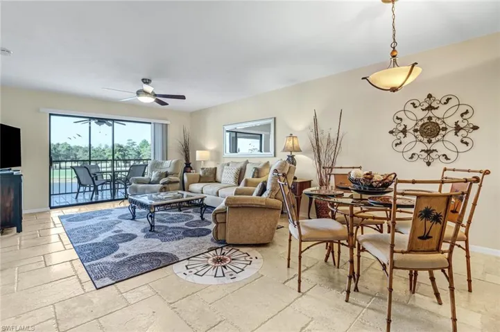 Living room with ceiling fan and light tile floors