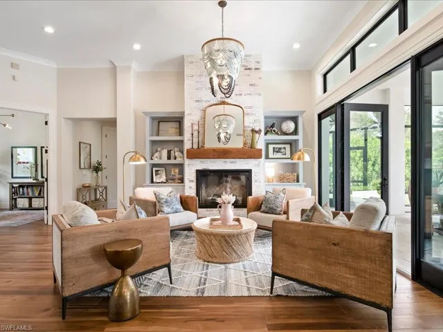 The homeowners added the gorgeous brick chimney and electric fireplace with custom built in cabinets in a soft blue flanking each side.