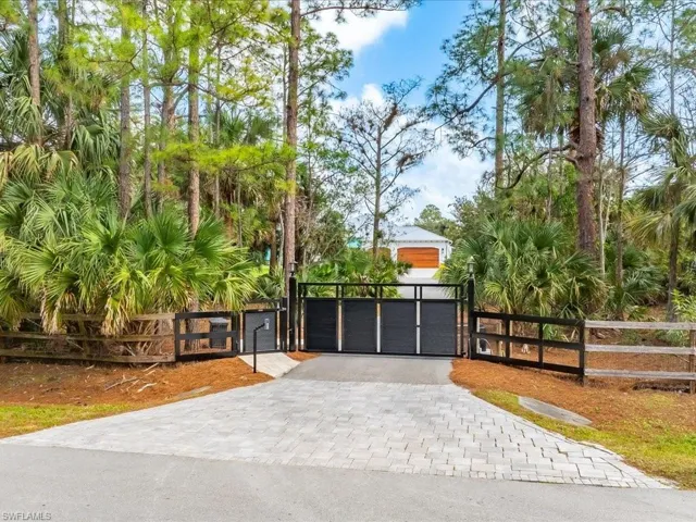 The entire property is fenced and secured with the electric security gate and surveillance cameras on the entire exterior property. (2023)