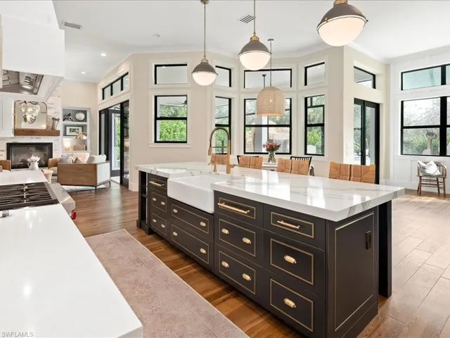Two dishwashers flank each side of the cast iron farmhouse sink. There's SO much natural Florida sunlight pouring through the transom windows.