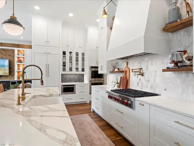 Floating shelves, glass front doors, and a 6-burner Wolf gas range with a pot filler check all the boxes (connected to the 1,000 gallon buried propane tank)