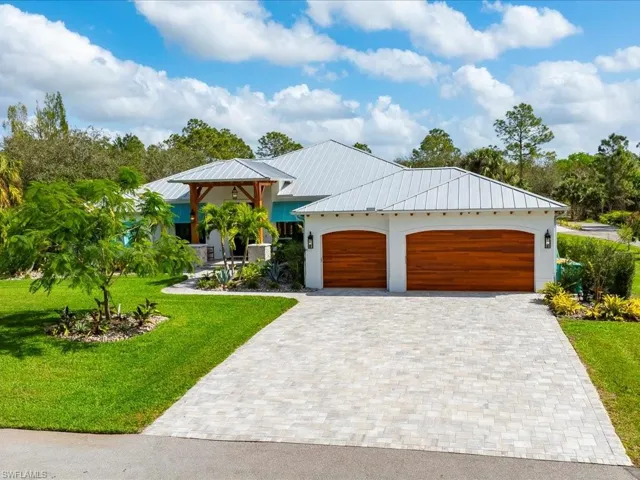New paver pads at the garage, the barn, and the exterior firepit. The driveway was extended and a fresh coat of asphalt was added the same year. (2024)