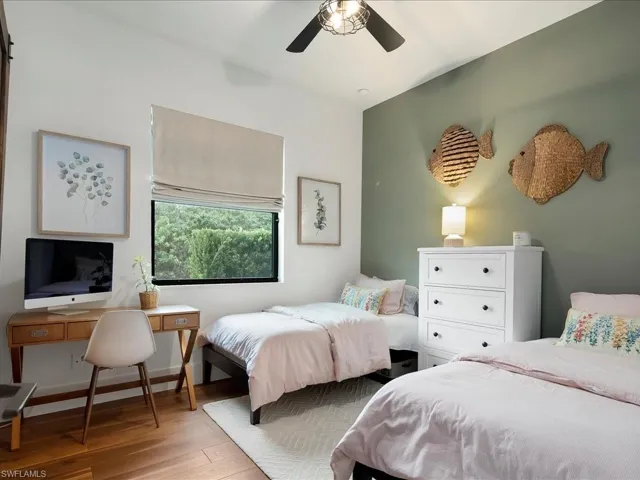 The third bedroom also has a ceiling fan, room darkening shades, and custom PLC closet shelving.
