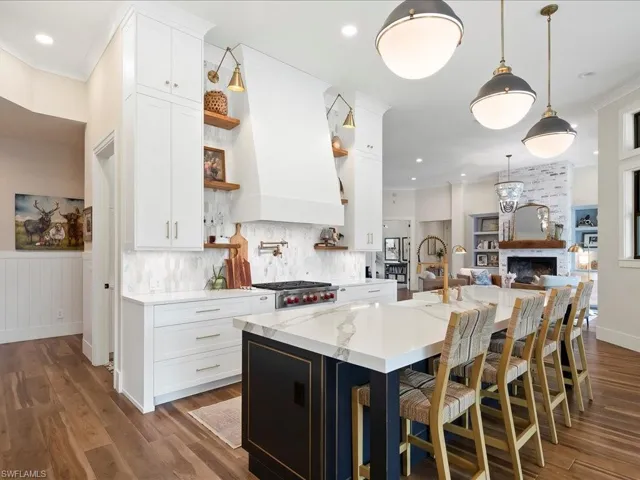 The two-tone cabinetry and sleek, modern pendants are a few of the many thoughtful details implemented by Design & Company.