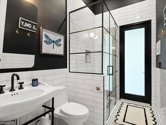 Near the office you'll find the extremely handy full guest/pool bathroom. Completely remodeled in 2024, the walk-in shower is perfect for rinsing off before a swim and even more ideal for bathing your pets!