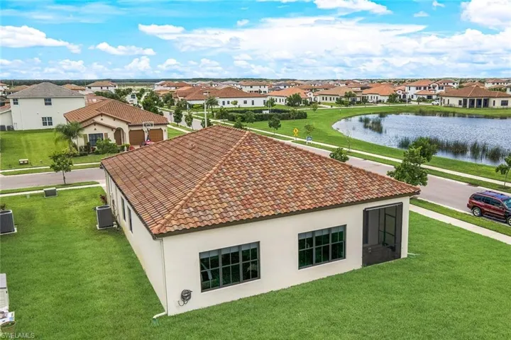 Aerial view of residential area featuring a nearby body of water