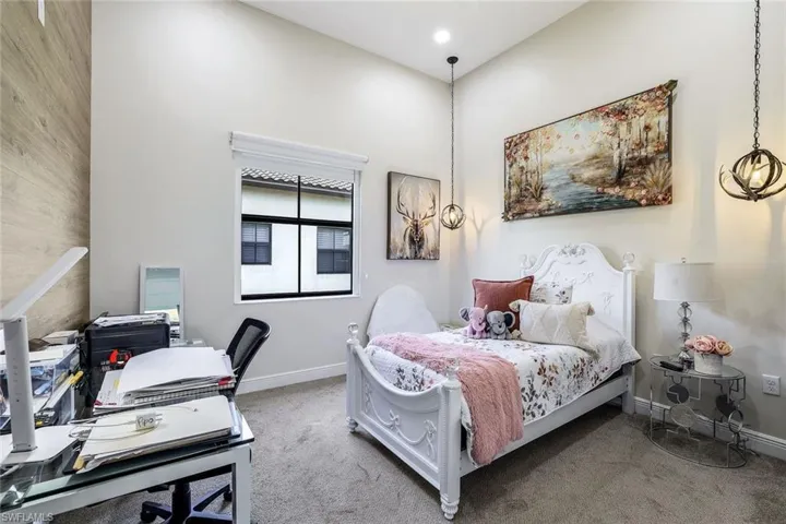 Bedroom with carpet and an office area