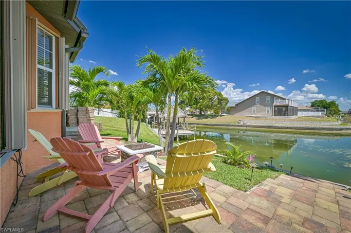 View of patio with a water view and a fire pit
