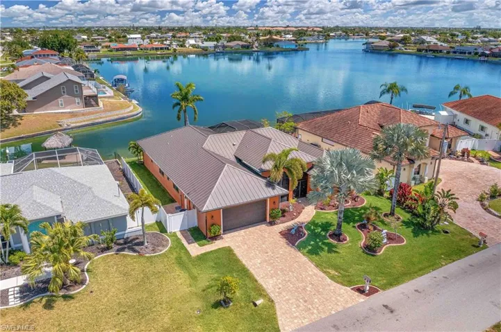 Aerial view of residential area featuring a nearby body of water