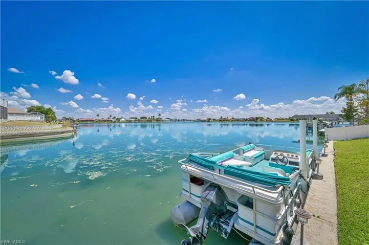 Dock with a water view and fence