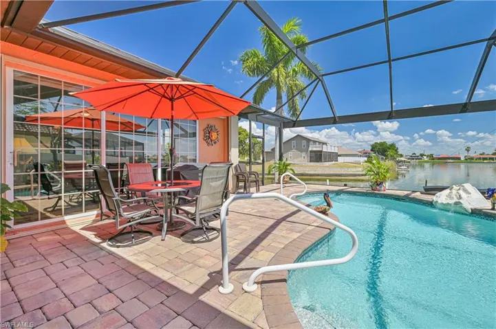 Pool with a patio and glass enclosure