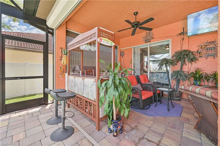 View of patio / terrace featuring an outdoor living space, a ceiling fan, and fence