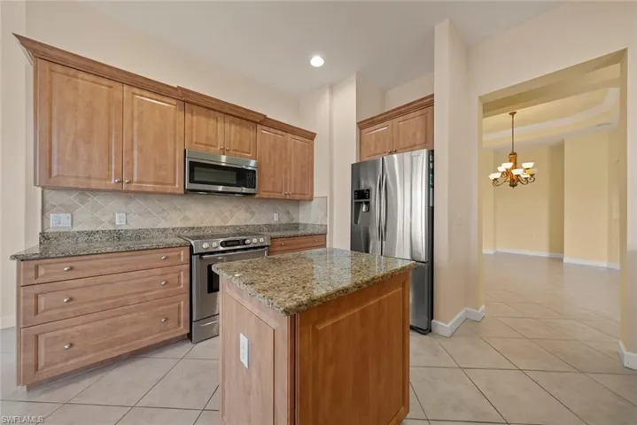 Kitchen featuring an island, granite counter tops and Bosh microwave and stove.