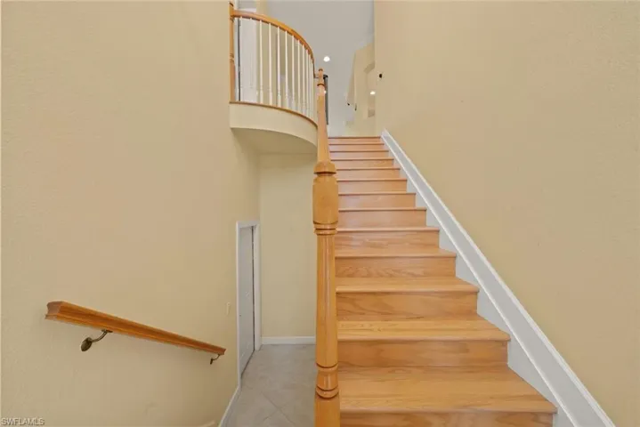 First floor entry with wood staircase.