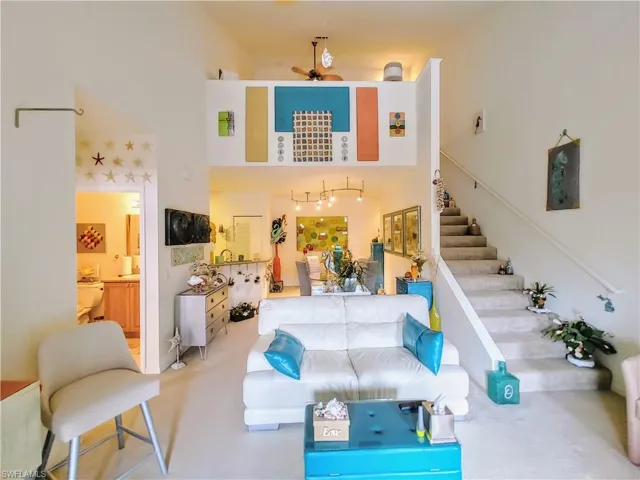 Living room with ceiling fan and carpet