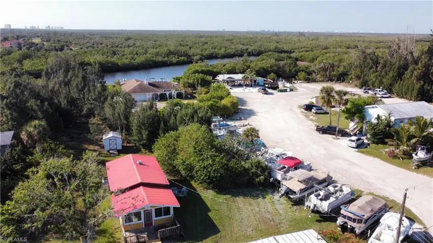 Drone / aerial view featuring a water view and a wooded view