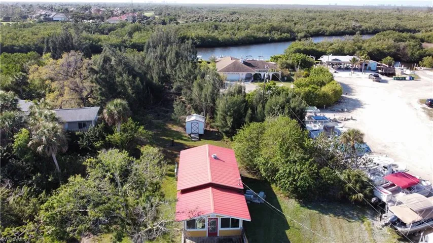 Drone / aerial view with a water view and a wooded view